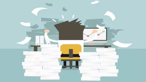 Businessman overwhelmed paper